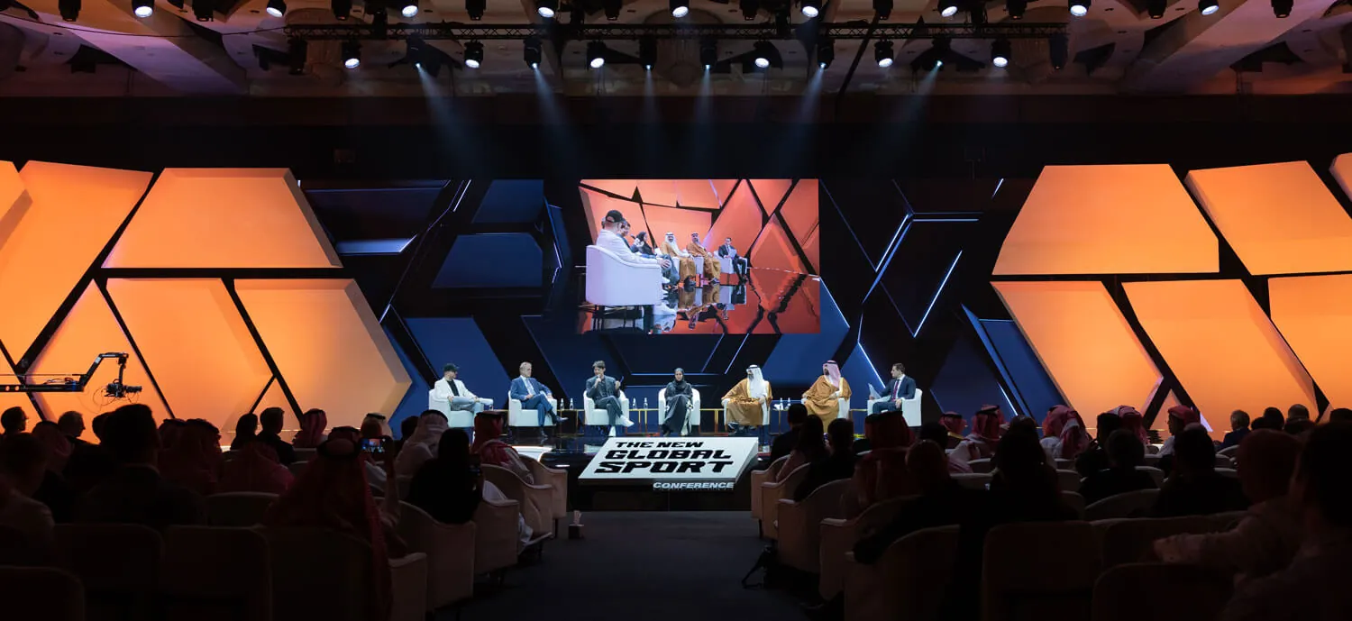 Panel discussion at NGSC with global sports and esports leaders on stage in Riyadh, Saudi Arabia, with large audience in attendance