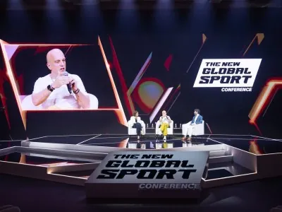 Panelists discussing global esports strategies on stage at NGSC 2025 with live audience and branding screen