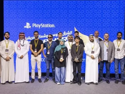 Group photo of NGSC 2025 speakers and guests on stage with the PlayStation logo in the background during the esports summit in Riyadh