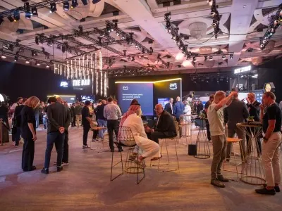 Networking and discussion zone at NGSC 2025, showing attendees engaged in conversations in a modern, well-lit exhibition space