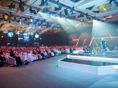 Ralf Reichert delivers a speech on stage at the New Global Sport Conference 2025 in Riyadh with a full audience of industry leaders and esports professionals