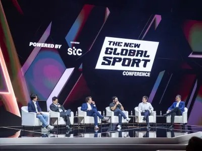 Panel discussion powered by STC at NGSC 2025, featuring global sports and esports leaders on stage under vibrant lighting.